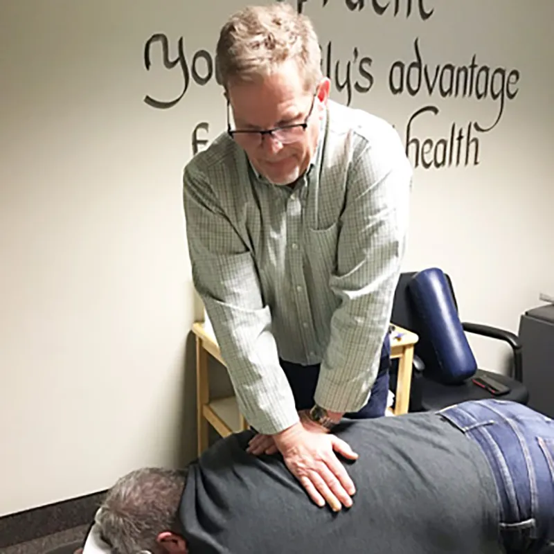 Dr. Kris adjusting a male patient