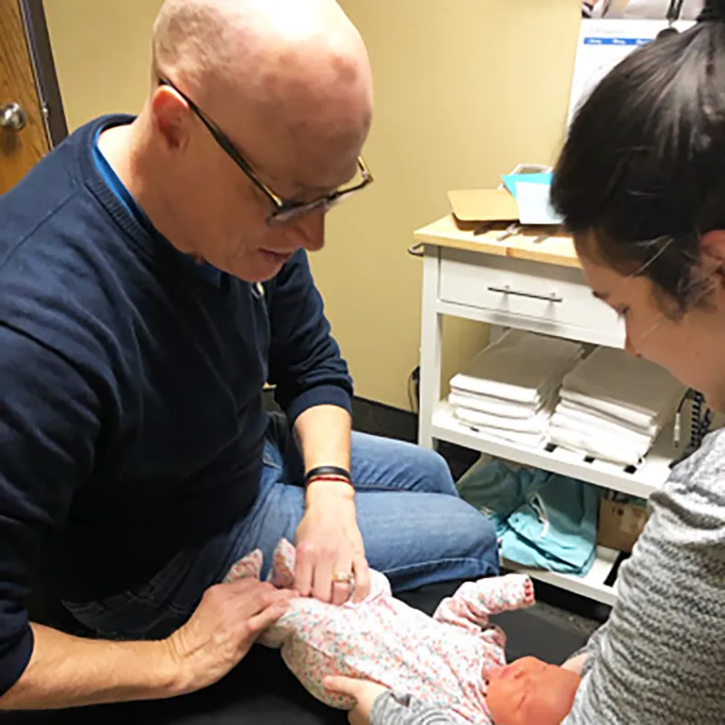 Dr. Robert adjusting a newborn