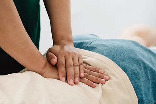 Close up of a chiropractor performing a lower pack adjustment