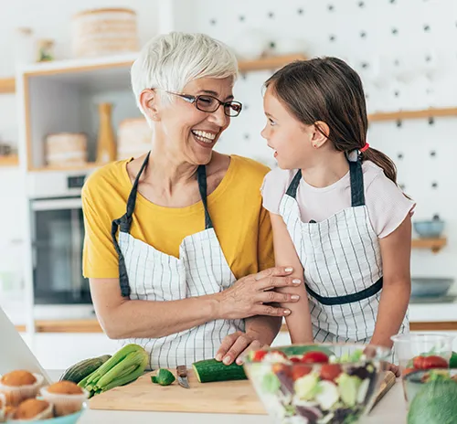 Woman and her granddaughter making a healthy meal together